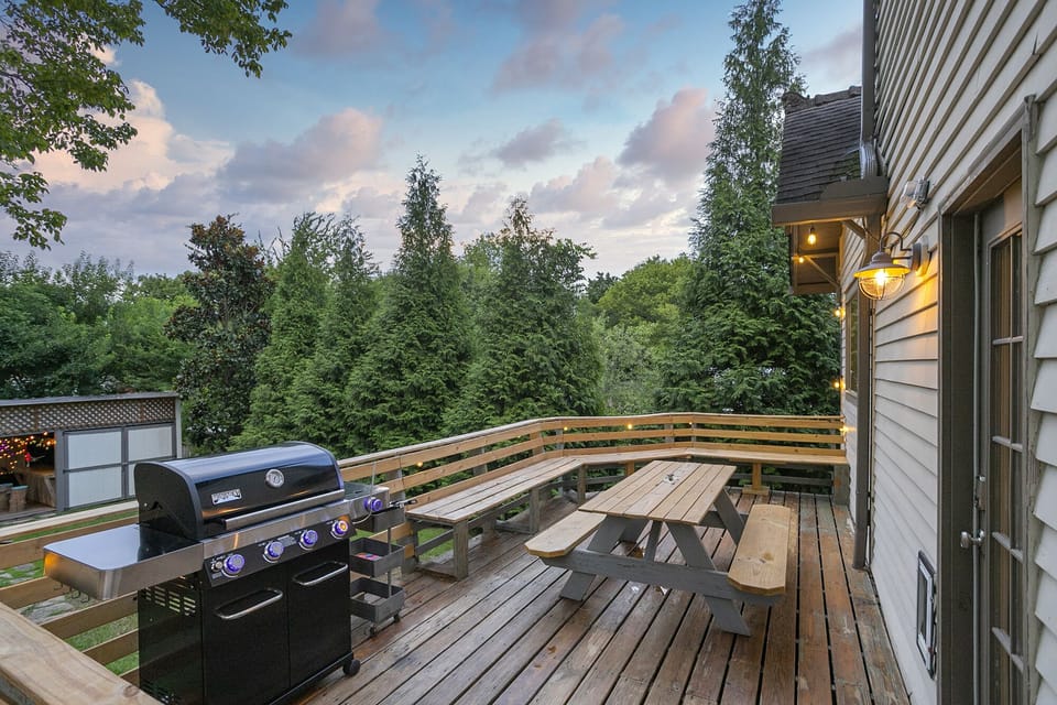 The backyard deck has a gas grill, picnic table and plenty of bench seating. 