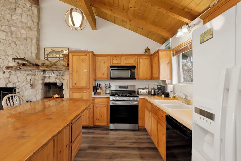 Fully equipped cabin kitchen with ample cabinetry, stove, fridge, microwave, and coffee maker—perfect for cooking meals, morning coffee, and feeling right at home on your stay.