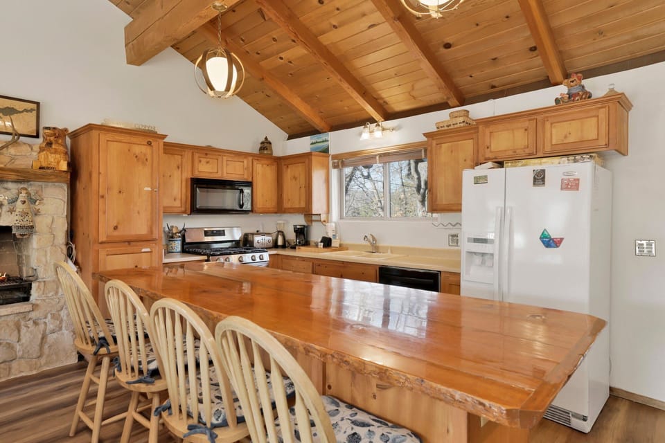 Fully equipped cabin kitchen with ample cabinetry, stove, fridge, microwave, and coffee maker—perfect for cooking meals, morning coffee, and feeling right at home on your stay.