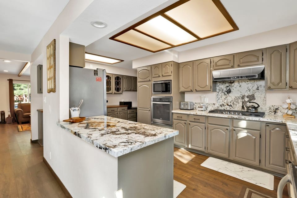 Fully equipped cabin kitchen with ample cabinetry, stove, fridge, microwave, and coffee maker—perfect for cooking meals, morning coffee, and feeling right at home on your stay.