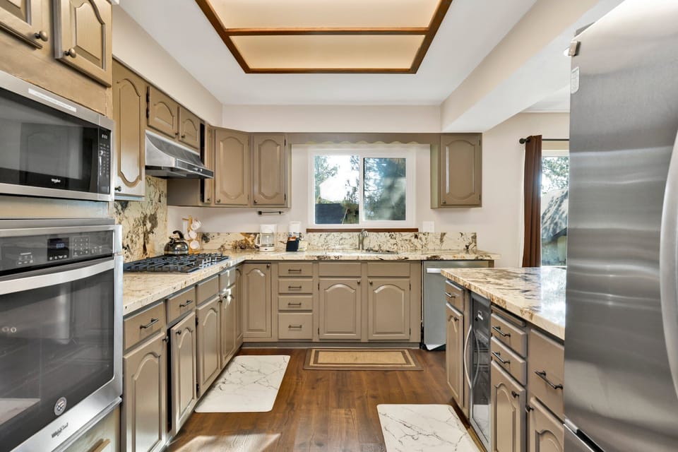 Fully equipped cabin kitchen with ample cabinetry, stove, fridge, microwave, and coffee maker—perfect for cooking meals, morning coffee, and feeling right at home on your stay.