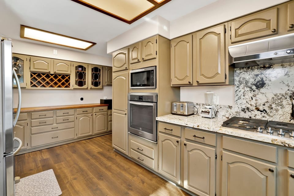 Fully equipped cabin kitchen with ample cabinetry, stove, fridge, microwave, and coffee maker—perfect for cooking meals, morning coffee, and feeling right at home on your stay.