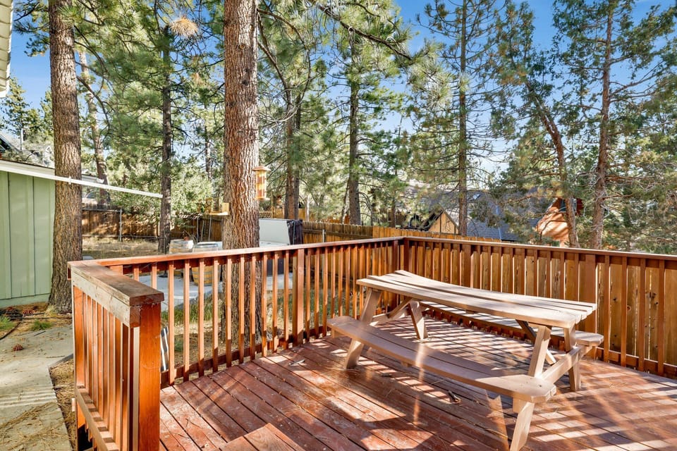 Private outdoor hot tub, surrounded by tall pines, perfect for relaxing under the trees after a day of adventure—enjoy peaceful forest views, fresh air, and a truly rejuvenating stay.