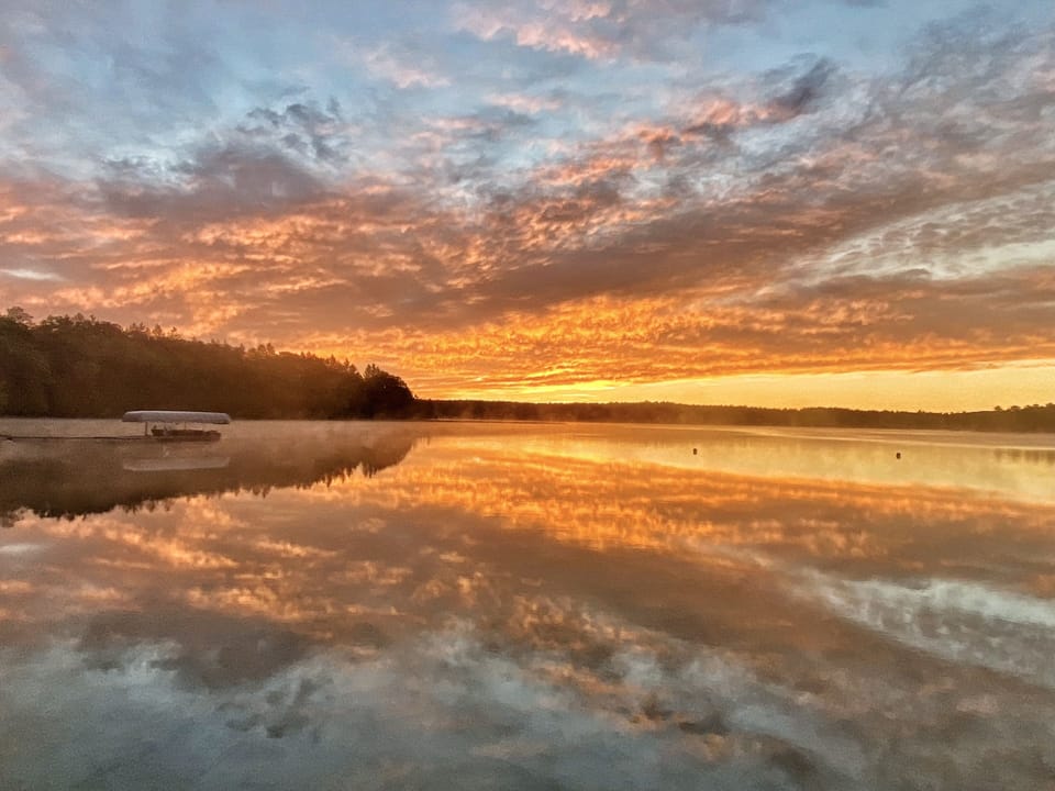 Golden sunrise with east dock and our 1955 Chris Craft.