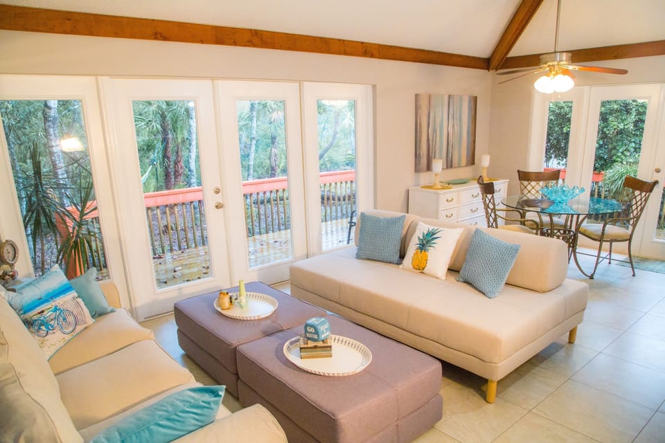 comfy couch and double bed sofa and two fold out twin ottomans in living room. 