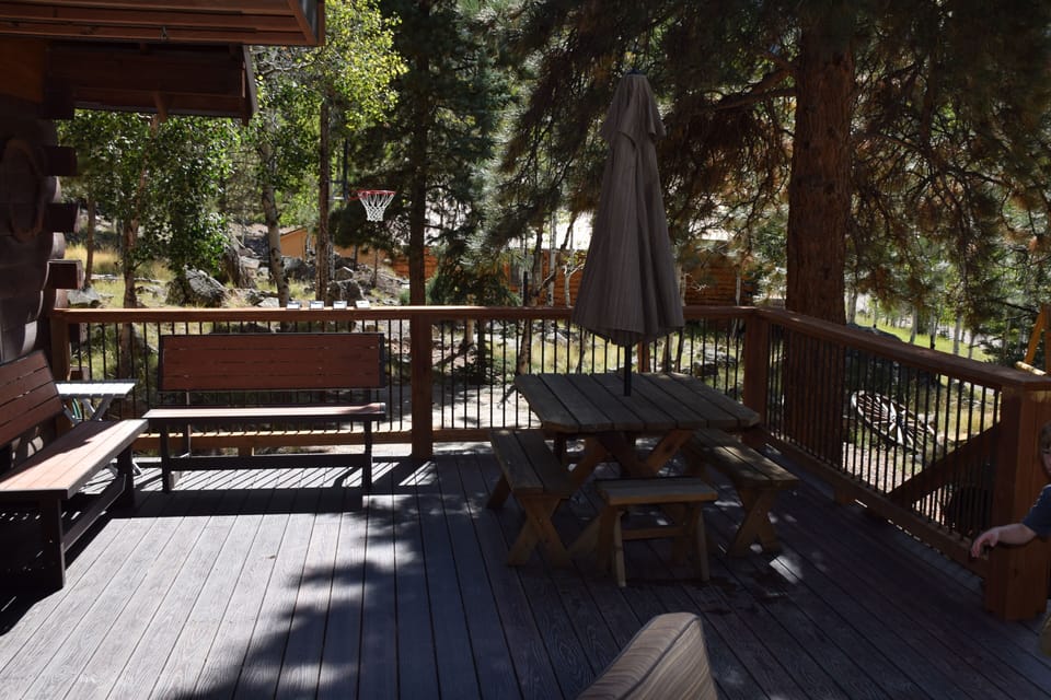 1/2 of main deck. Basketball court in background. Benches convert to tables