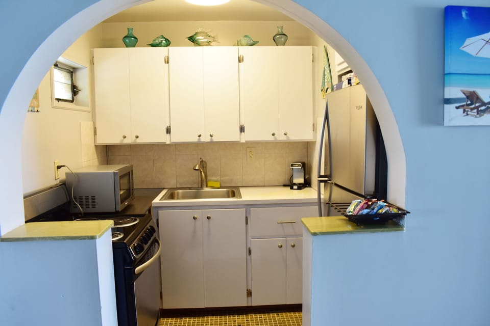 Full Kitchen, refrigerator, stove, microwave, coffee pots, pots and pans.