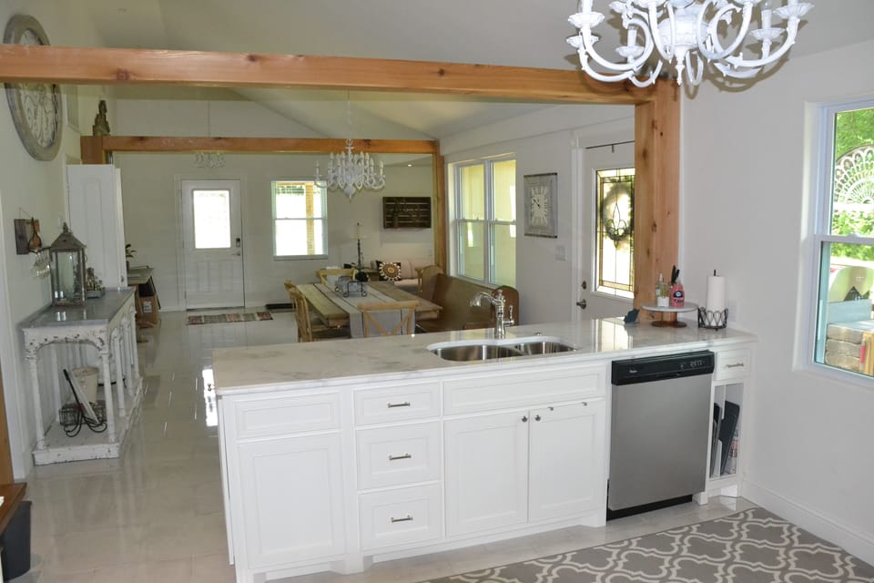 View from kitchen to dining. Furnished dishwasher, range, microwave & fridge