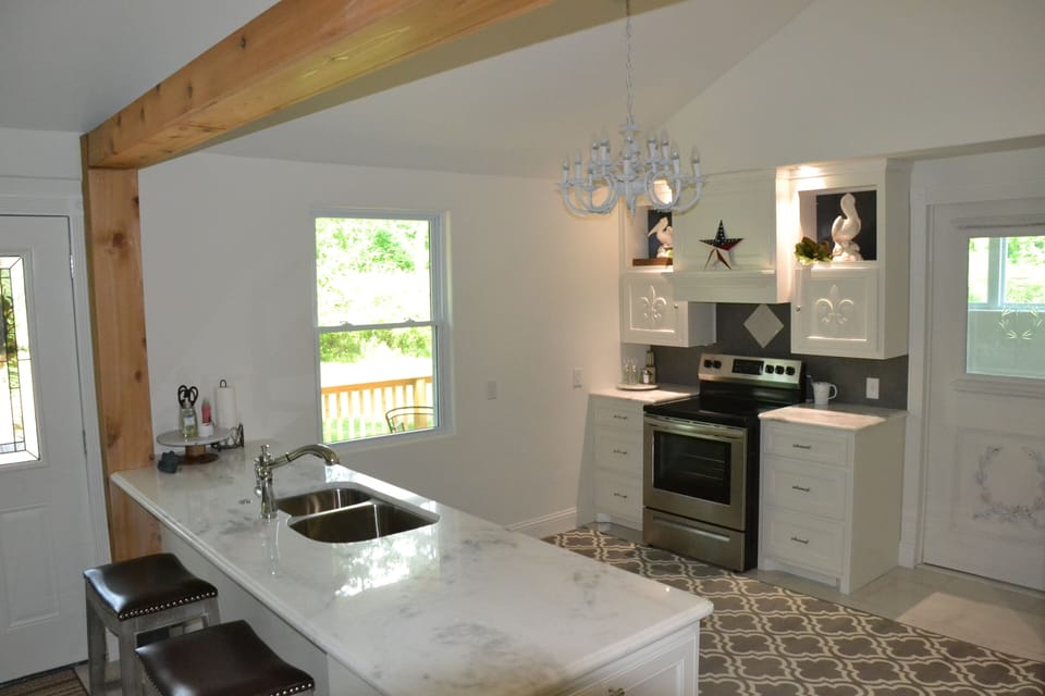 View from dining to kitchen. quartz counters-pots, pans & utensils furnished