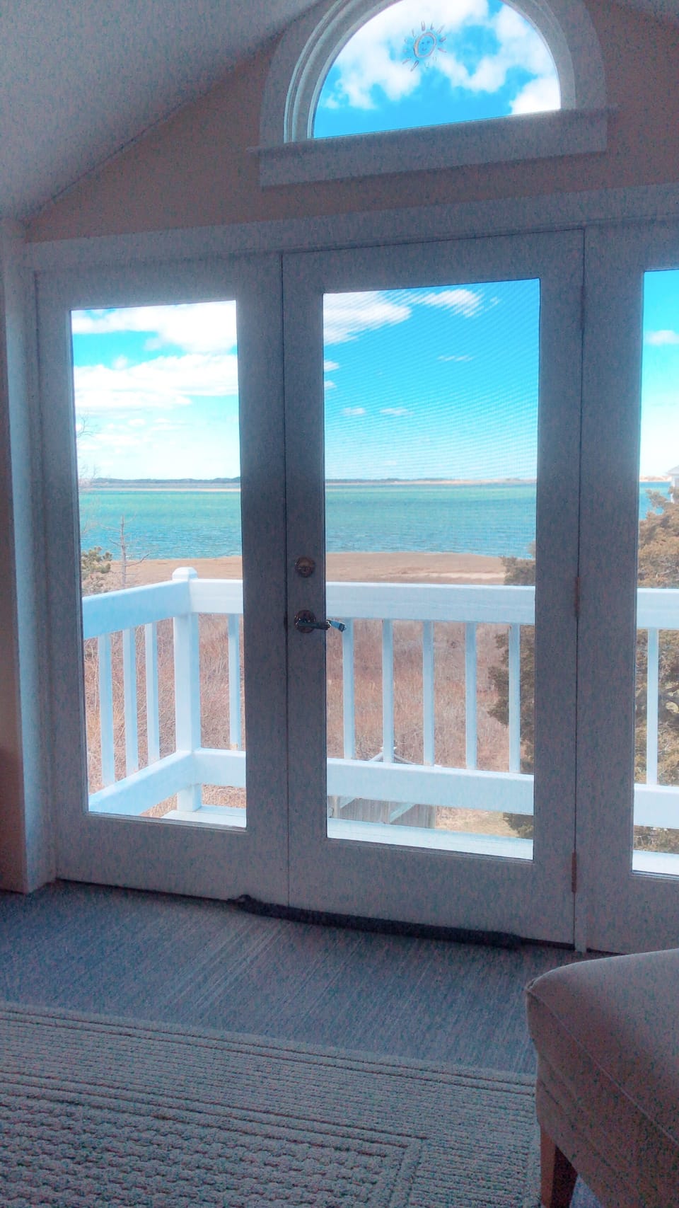 A view of the inside looking at the ocean during the fall season.