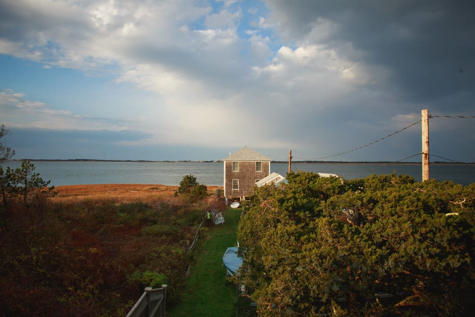 Walk a few steps (30 seconds) along grass to reach the private beach.  Ocean/beach access is  immediately in front of shown oceanfront house.  During flood tides (real high tides) the ocean often run underneath the ocean front house.  During a regular high tide, the ocean is just footsteps in front of it.