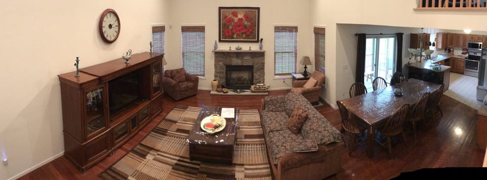 Living room w/Samsung Smart TV and gas fireplace , transitions into dining area 