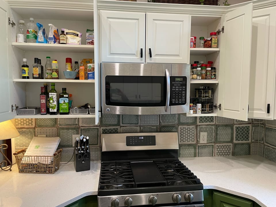 Kitchen is stocked with spices and basic cooking oils.