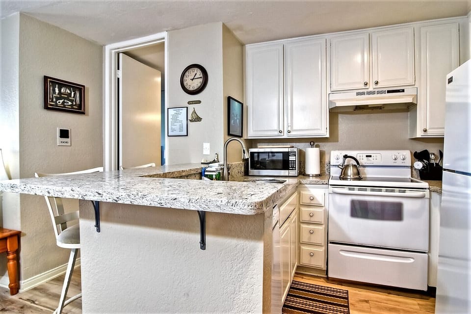 Kitchen is fully equipped with stove, refrigerator, microwave and dishwasher.