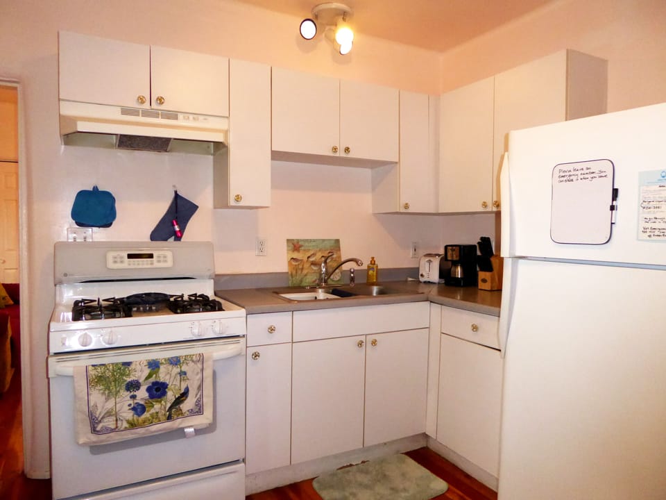 Kitchen range, counter, appliances. Many small appliances are available.