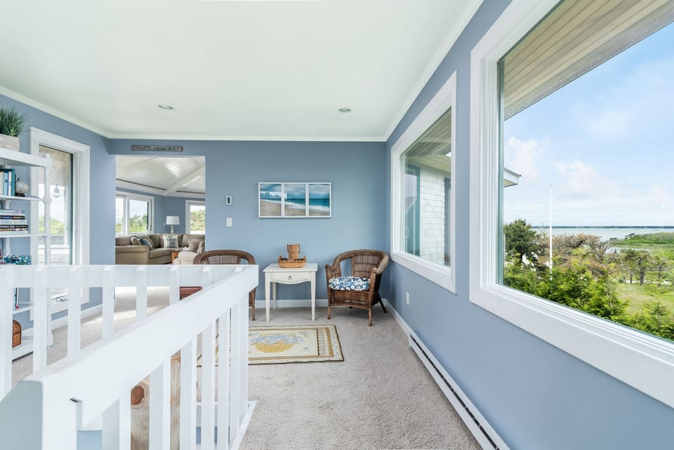 Upstairs seating area surrounded by windows 