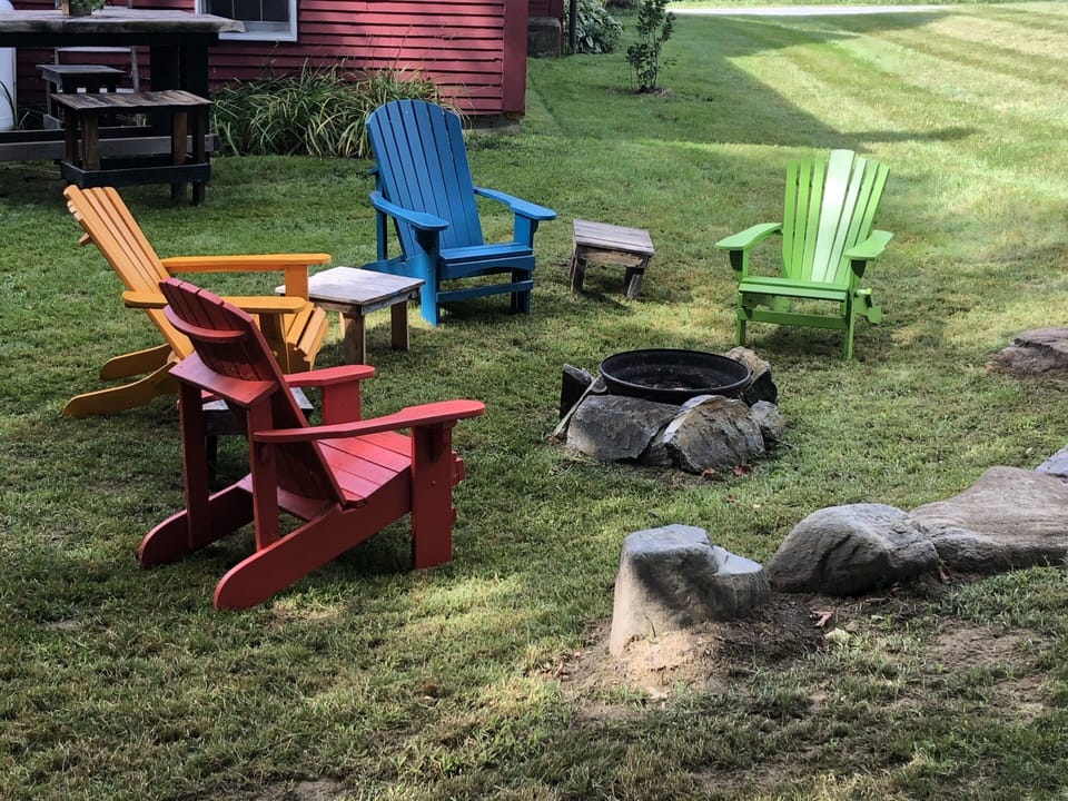 Adirondack chairs make it easy to hang out all evening. Firewood is provided 