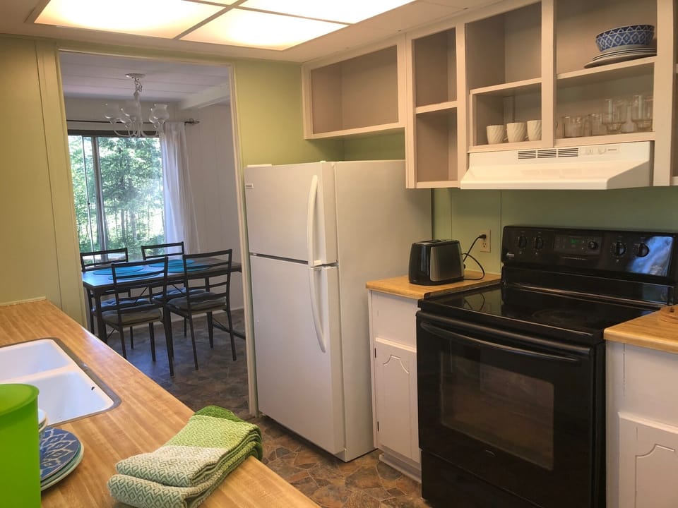 Kitchen with refrigerator, full-size stove, dishware, pots and pans! 