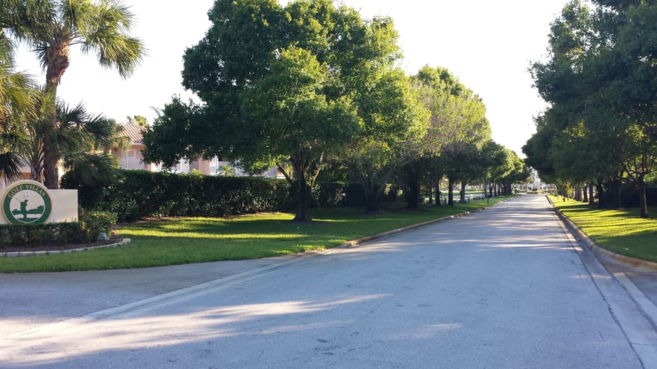 End of this tree lined road you have PGA Clubhouse. Yes..You can walk there