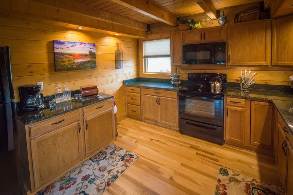 fully stocked kitchen with granite countertops