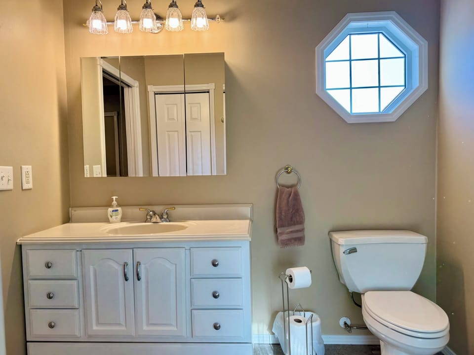 En suite bathroom w/ full tub and shower. Towels and wash cloths provided