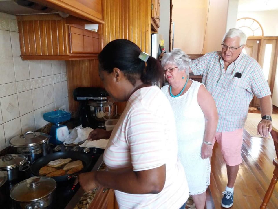 Guests witnessing preparation of fish they will enjoy at this Bajan home
