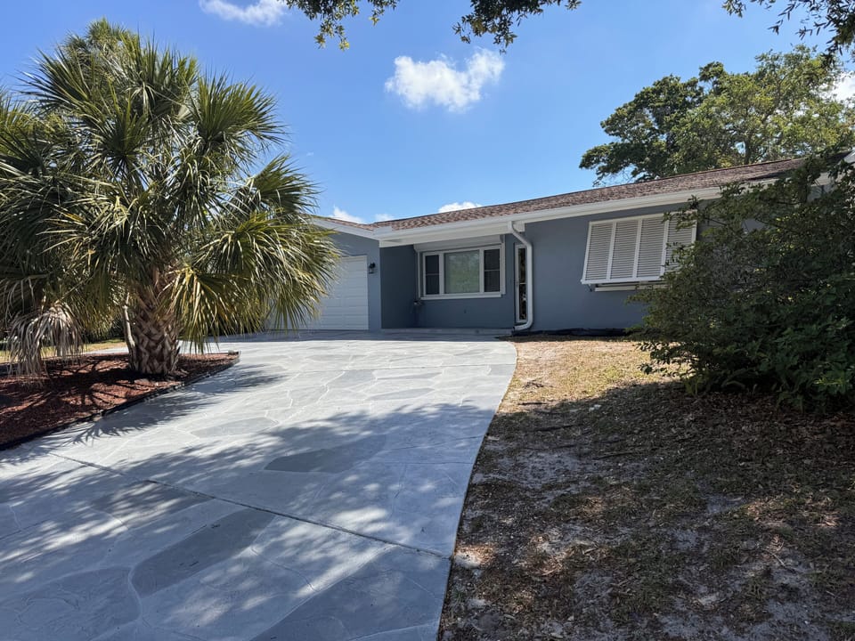 Front. Driveway is pitched uphill