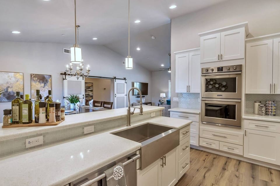 Completely remodeled and updated Kitchen - white countertops & cupboards, stainless steel farmhouse sink, and top-end Frigidaire Professional appliances. 