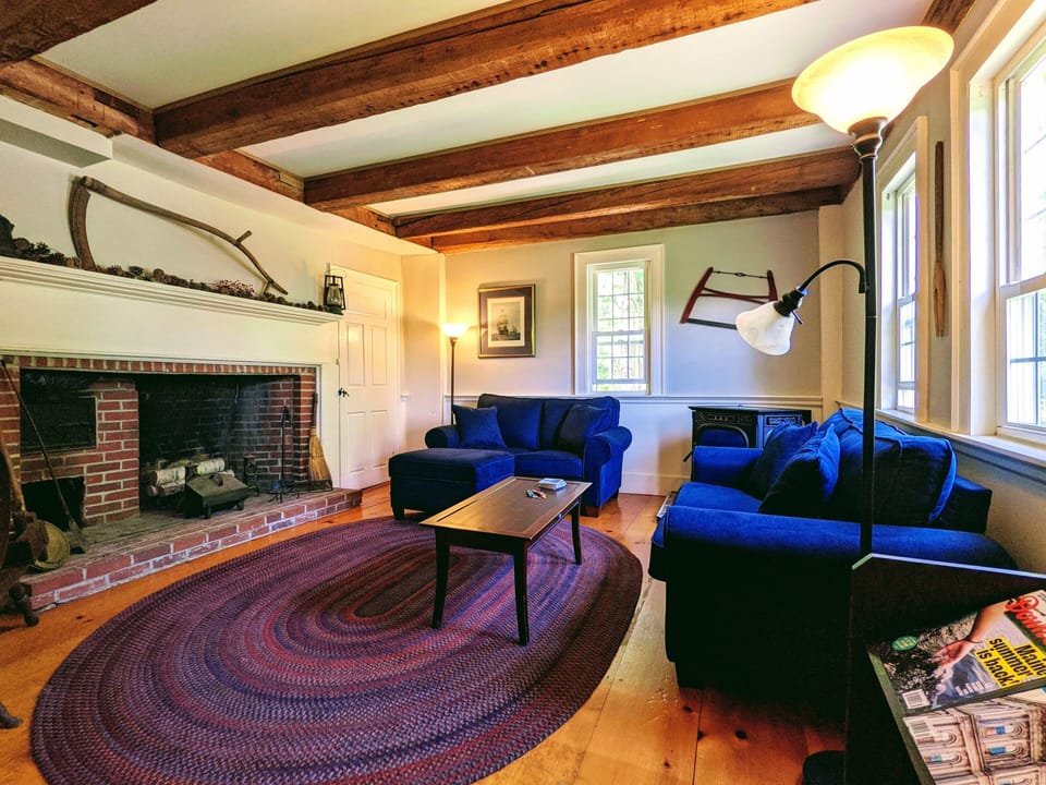 Private living space with 1700s woodwork, bookcase and pellet stove