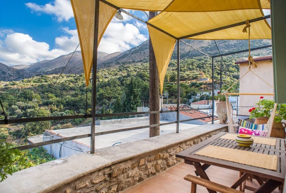 Terrace outside the room with dining table and great mountain views
