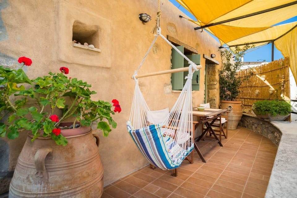 Terrace outside the room with dining table and a hammock
