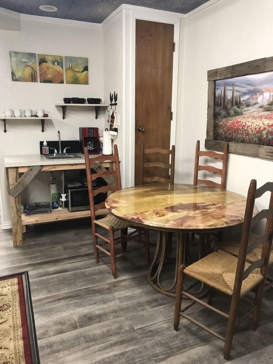 View of onyx table, 4 ladder back chairs & coffee bar