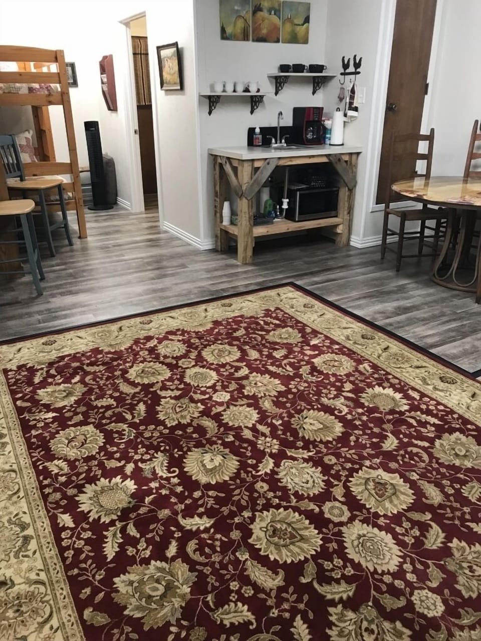 Coffee bar, microwave, sink & table view with a set of twin/twin bunkbeds left