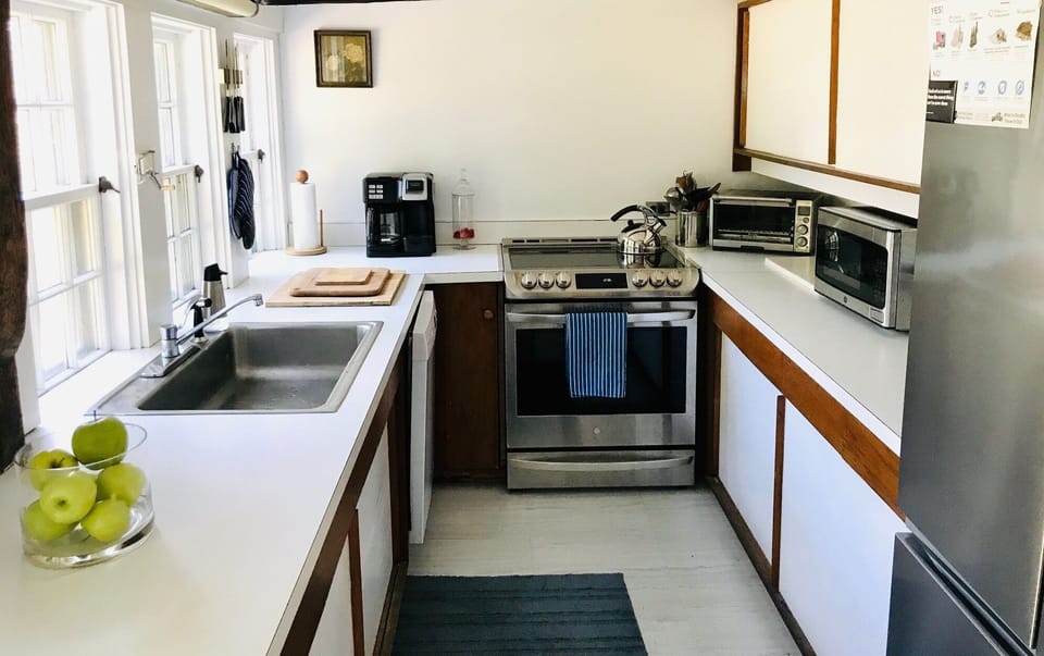 Main house kitchen with full size, stainless steel fridge and oven+ 