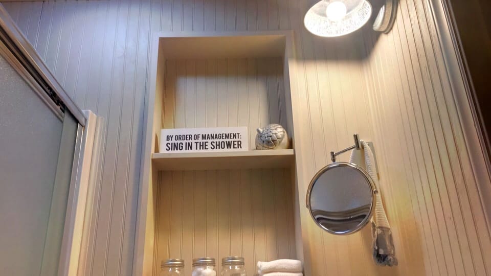 Tiny bathroom with separate dressing closet. Toiletries, hair dryer, iron