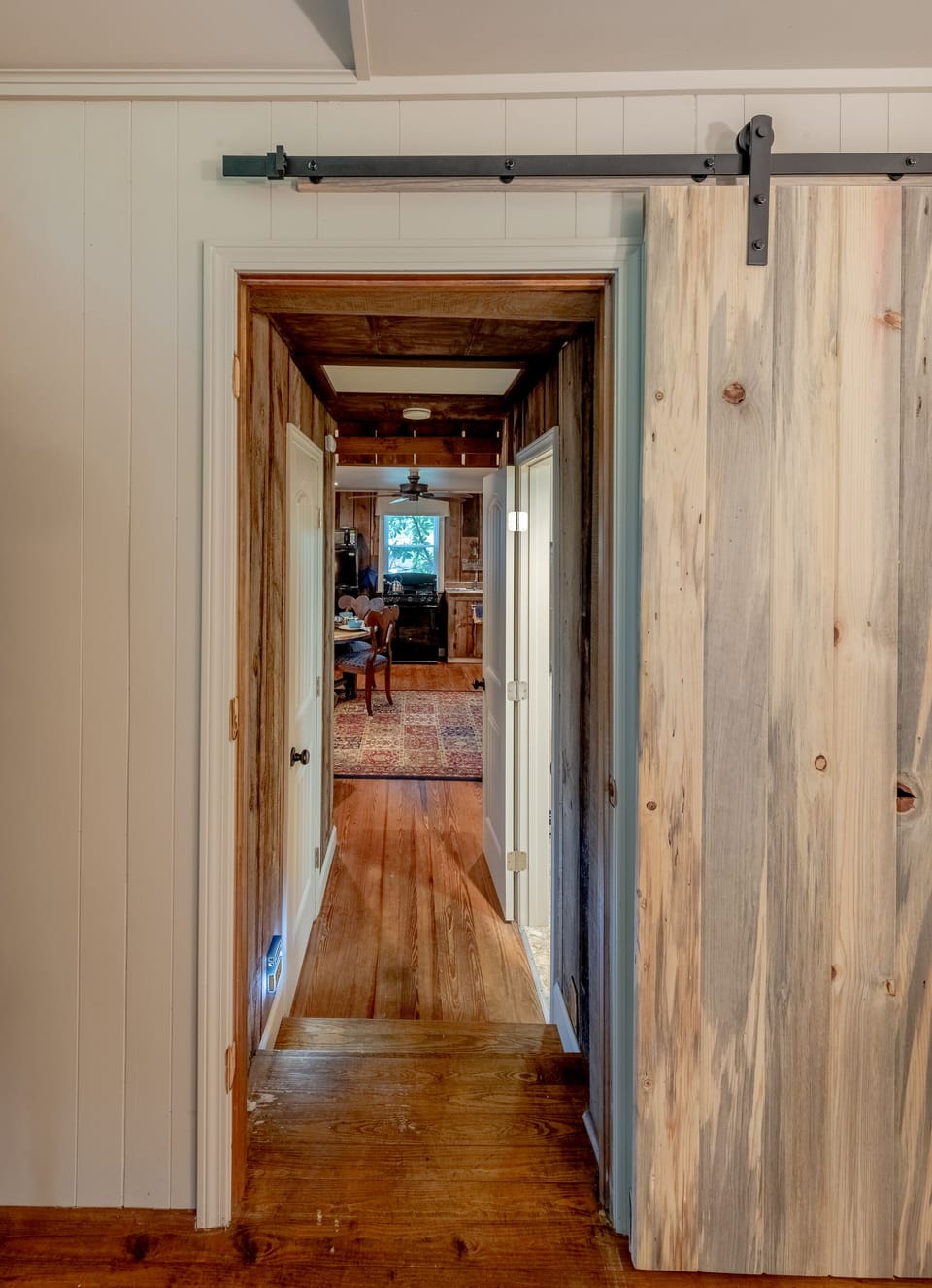 Barn door separates sleeping lodge to main living that was originally the barn.