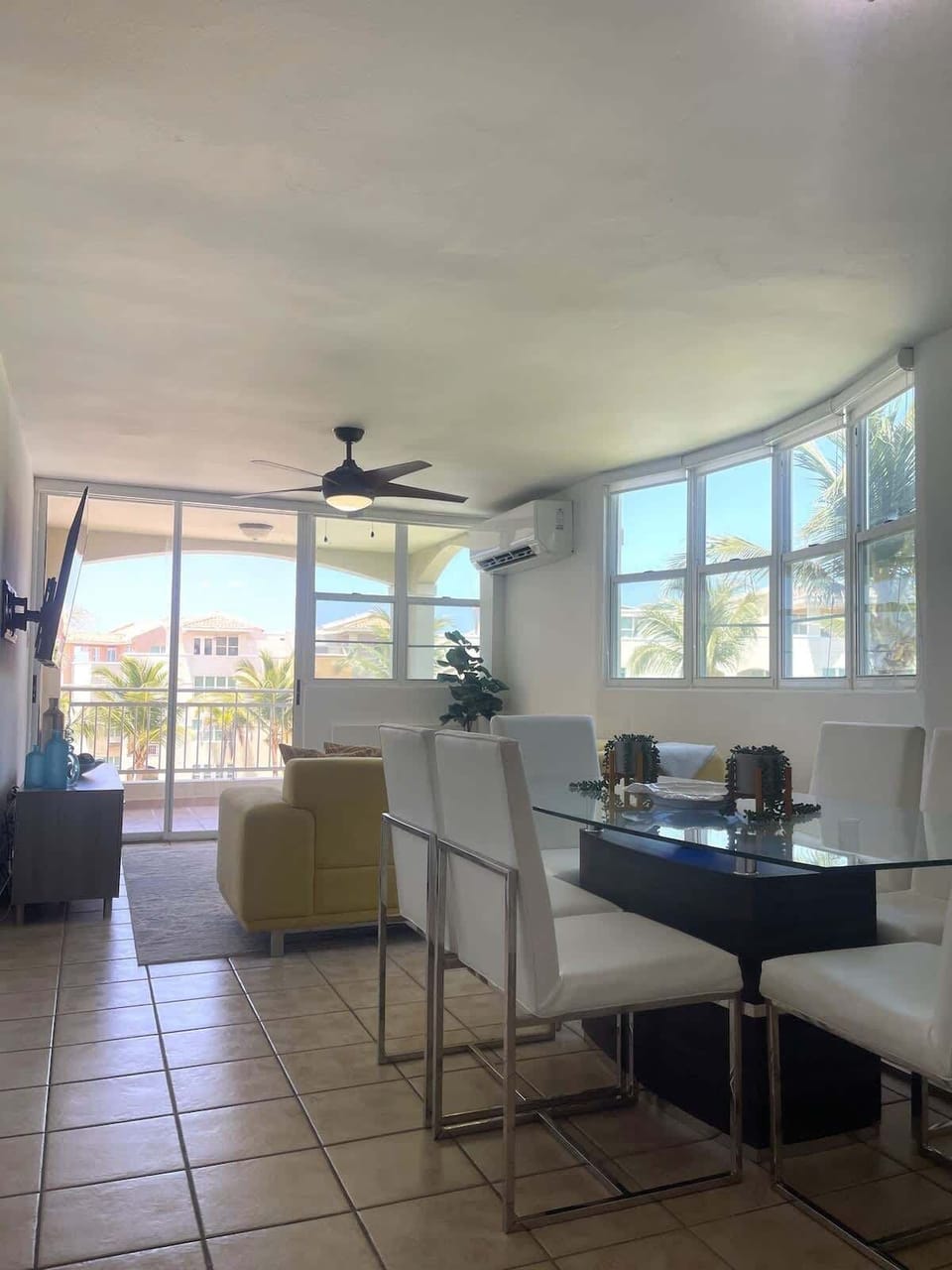 Spacious open-plan living, dining, and kitchen area with stunning views of the pool and beach.