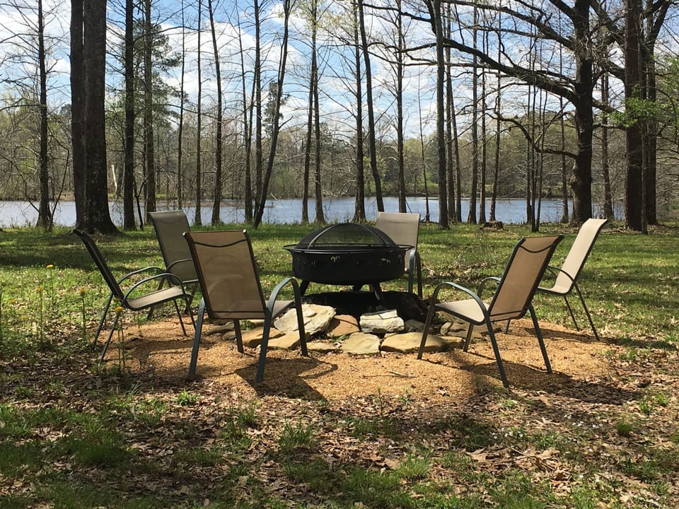 firepit over looks one of the 2 lakes on the 151 acre property