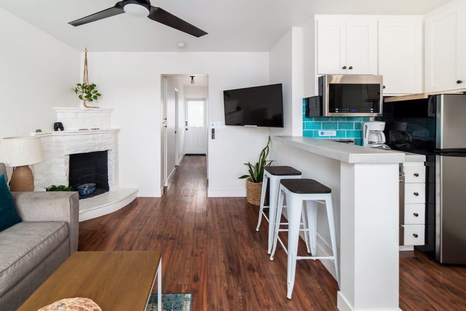 Partial ocean view living room with smart television. Netflix and HULU with Live TV accounts signed in for guest use.