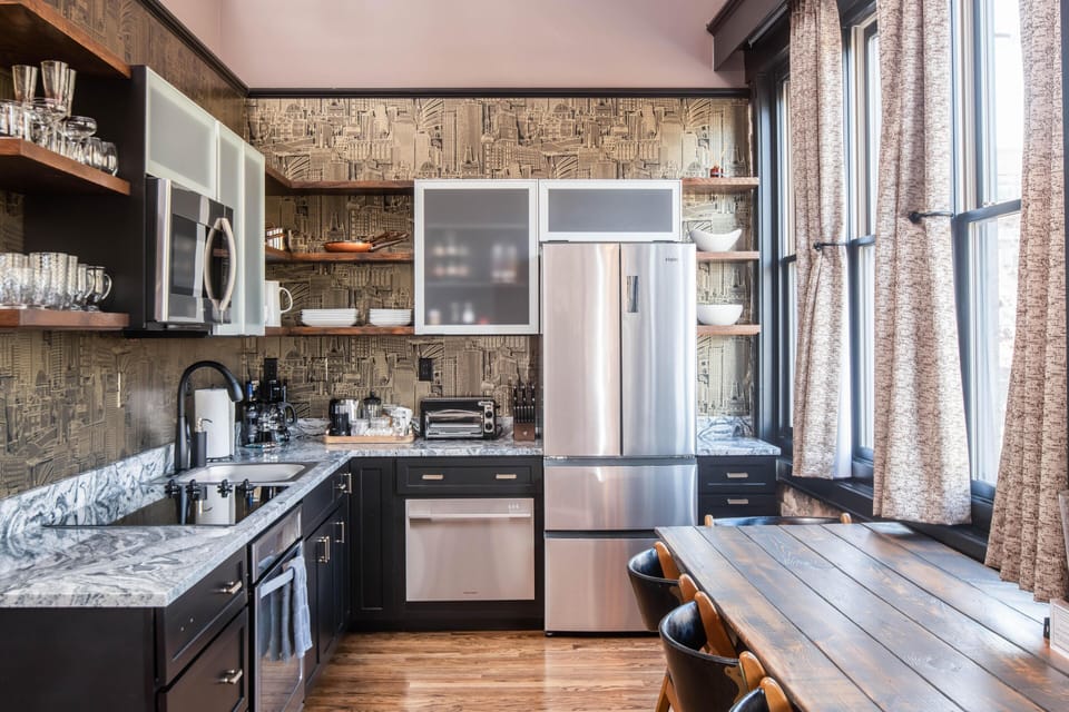 Fully  stocked kitchen with all the essentials: coffee, creamers, tea, sweeteners, cookware, dining ware , paper products and a view of N. Lexington Avenue