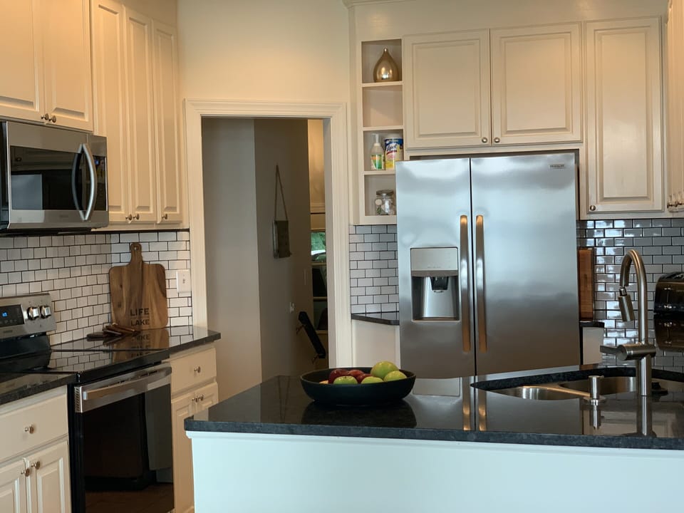 Newly updated counters and appliances with fully stocked kitchen. 