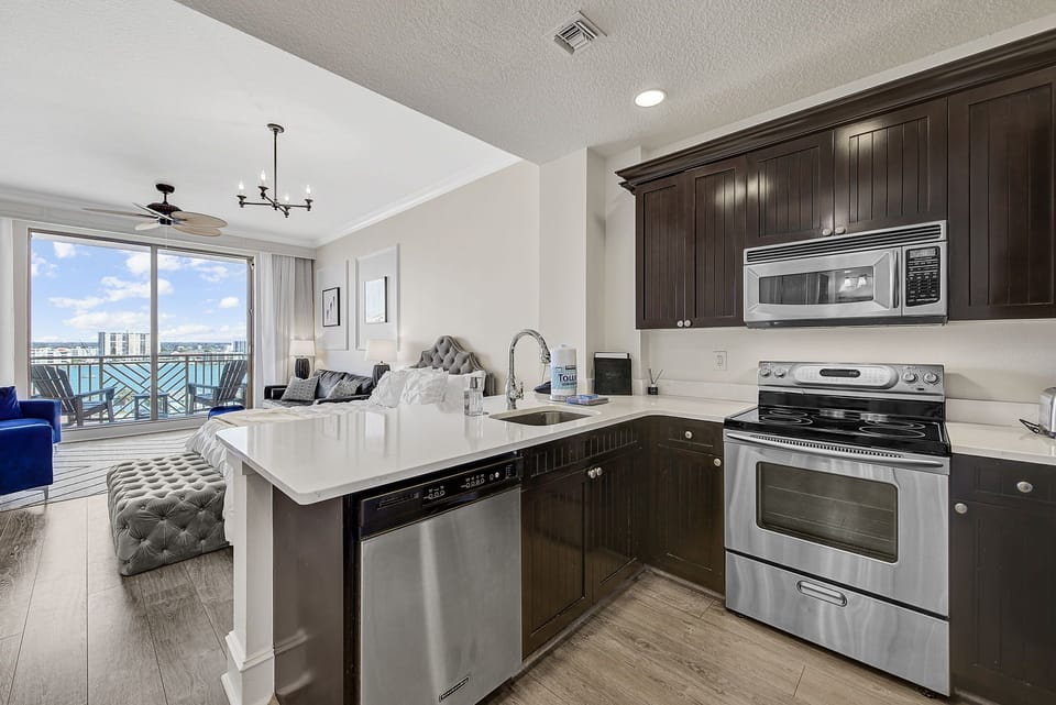 Open kitchen with 3 bar stools for in-suite dining.