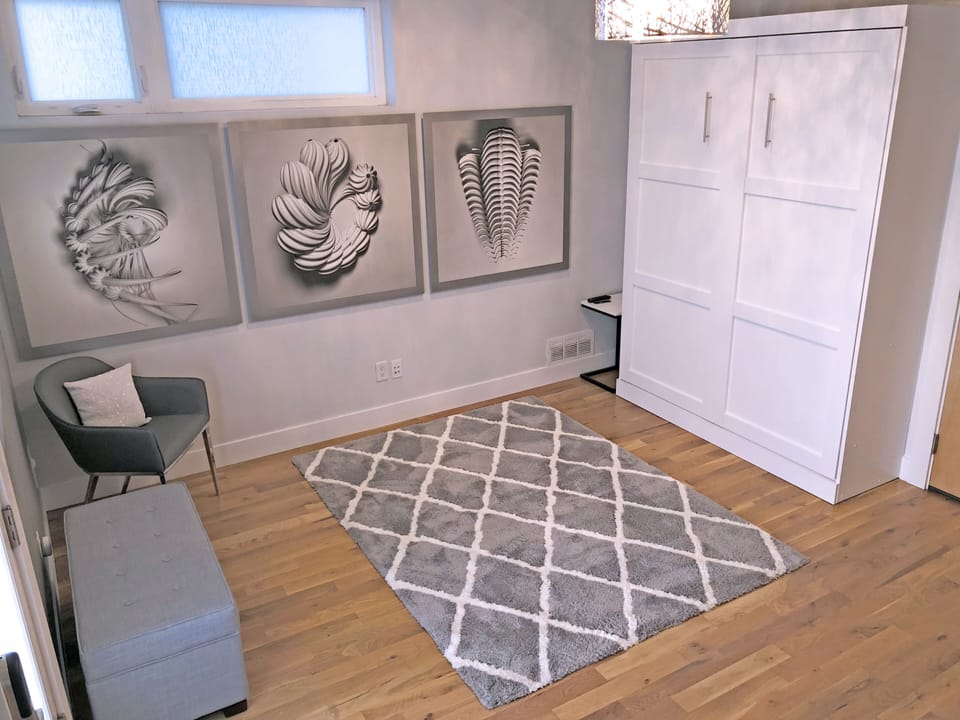 Main Floor Entry Bedroom with Queen Size Murphy Wall Bed.  Not fully private