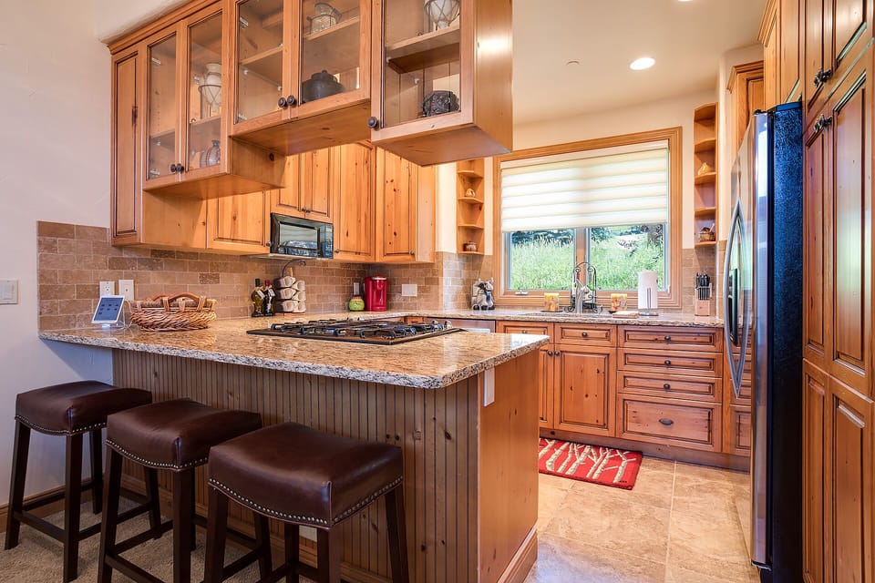 Your gourmet kitchen features warm wood cabinetry, granite countertops, and stainless appliances for memorable cooking experiences.