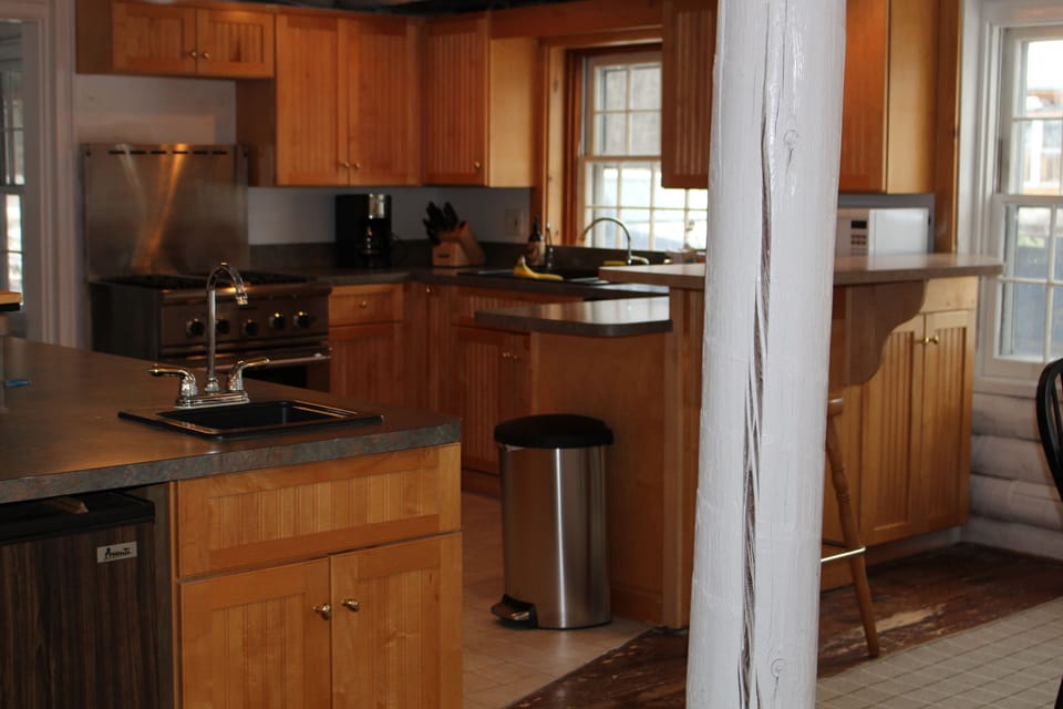 Kitchen has high end stove and two sinks. 