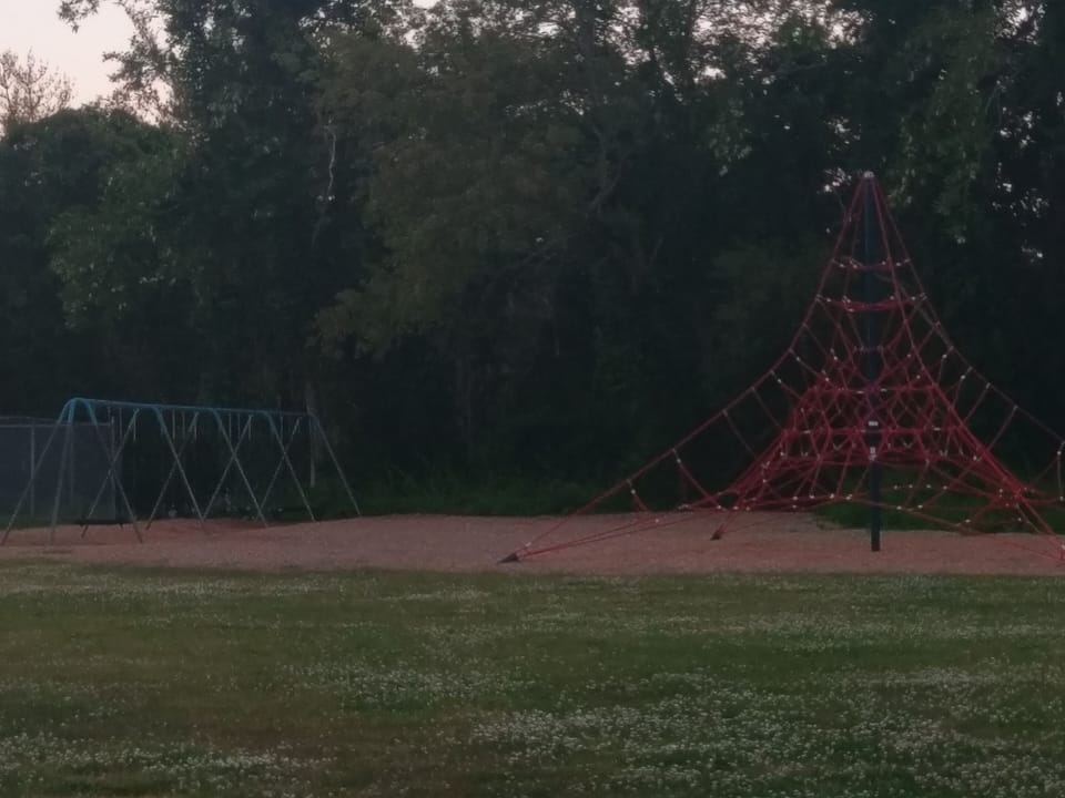 Swings and climbing equipment at adjacent school yard