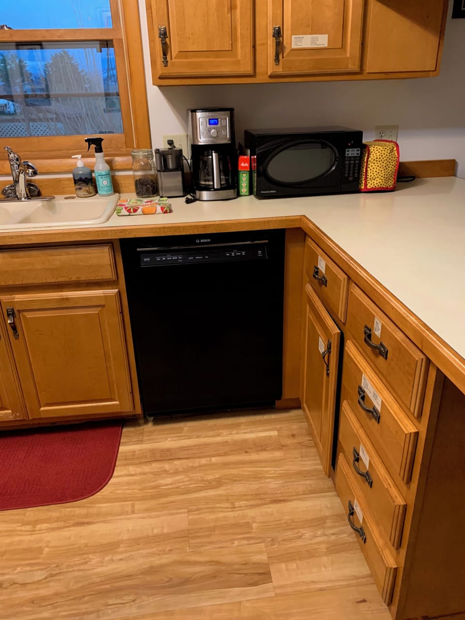 Dishwasher, coffee maker, microwave, toaster, cupboards labeled for you.