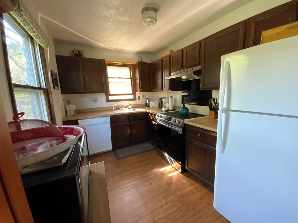 Kitchen with Induction Stove, Microwave, Dishwasher, and Refrigerator Freezer