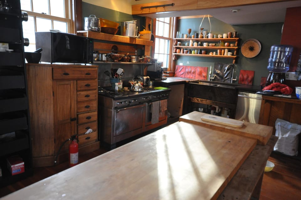 Kitchen: handmade cups, Garland stove, double soapstone farm sink, farm table.