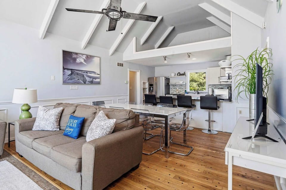 Living area with sightline to kitchen and dining